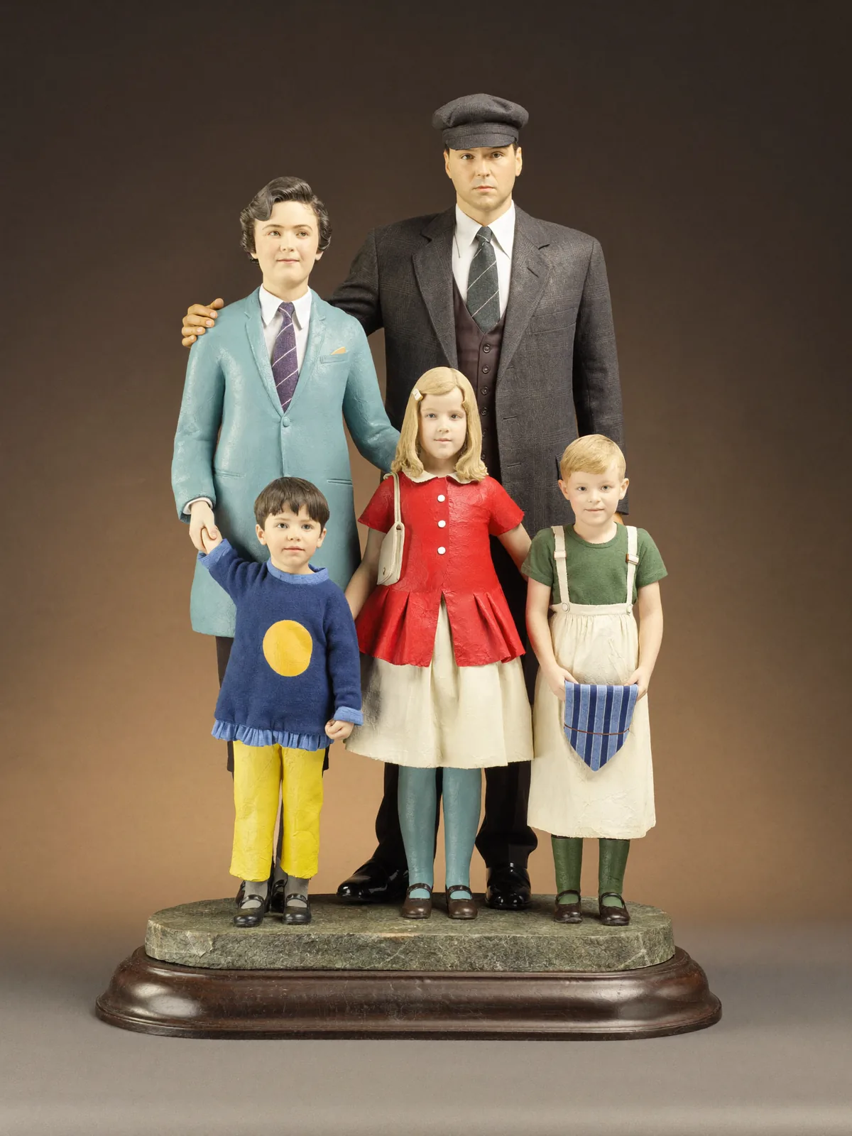 Grouped sculpture of a family on a single shared base. Grouped figures, 12″ (30 cm), single base, 26 painting hours